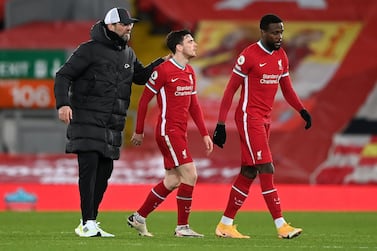 Jurgen Klopp, manager of Liverpool consoles Andrew Robertson, and Divock Origi following the defeat against Everton at Anfield. Getty