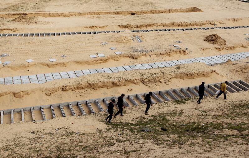 Palestinians prepare graves near the Egyptian border in Rafah, southern Gaza, as the Israeli onslaught on the enclave continues. EPA