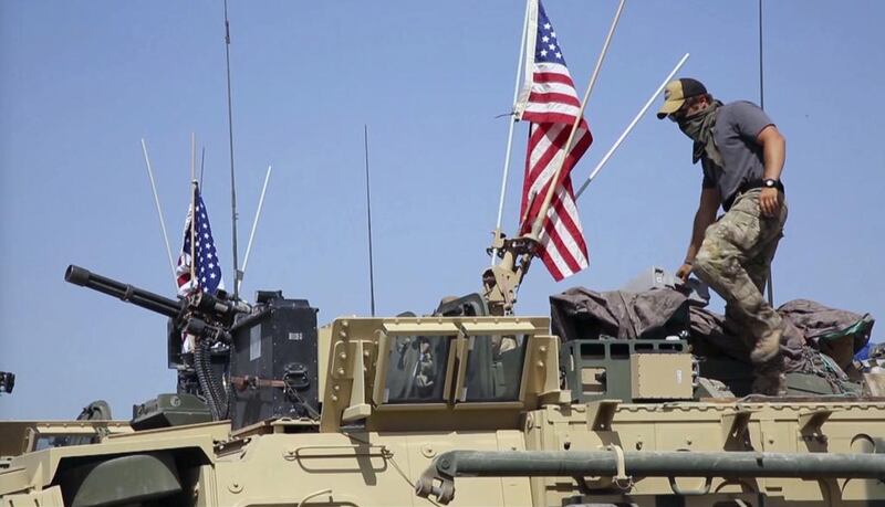 A US soldier stands on an armoured vehicle in the Syrian border village of Darbasiyah in this still from video filmed on April 29, 2017. AP Photo via APTV