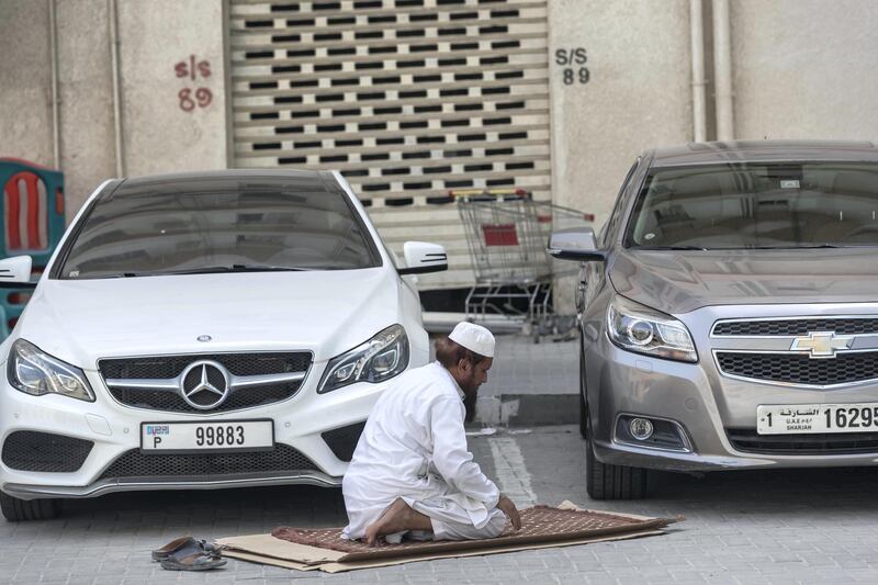 SHARJAH, UNITED ARAB EMIRATES. 04 APRIL 2020. COVID-19 Coverage. General image for gallery and related article. A man prays alone in a parkinglot in Sharjah. (Photo: Antonie Robertson/The National) Journalist: Standalone. Section: National.