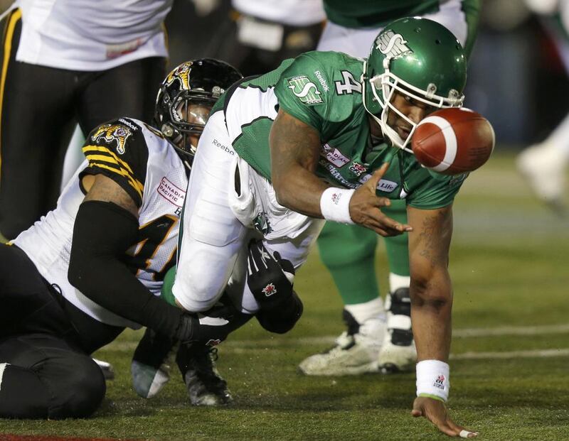  Darian Durant hands off as he is brought down by Hamilton Tiger-Cats Eric Norwood. Todd Korol / Reuters