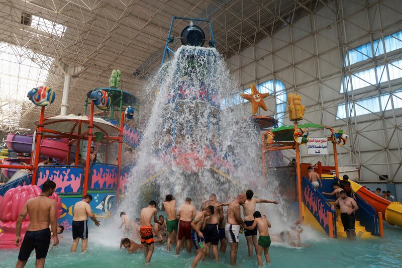 Iraqi youth cool off, during high temperatures at the Aqua Park in Baghdad on June 21, 2024.  Reuters