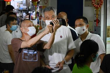 Singapore's Prime Minister Lee Hsien Loong poses for a selfie with a resident during a walkabout, ahead of last Friday's general election. AFP
