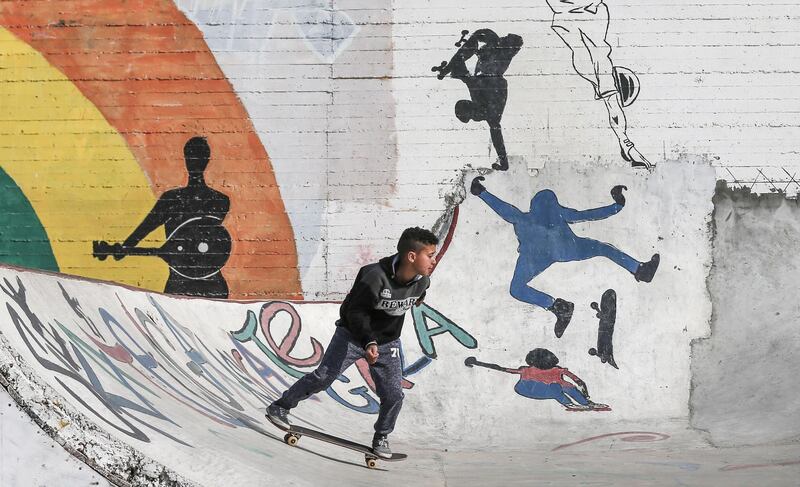 Palestinian youths ride their skateboards near the sea port of Gaza City. AFP