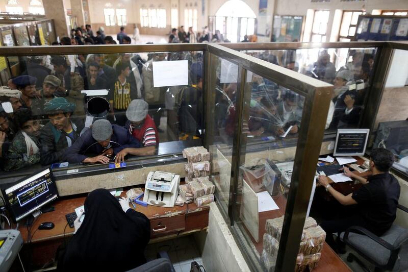 Public sector employees crowd at a post office to receive their salaries in Sanaa, Yemen on January 25, 2017. Khaled Abdullah / Reuters 