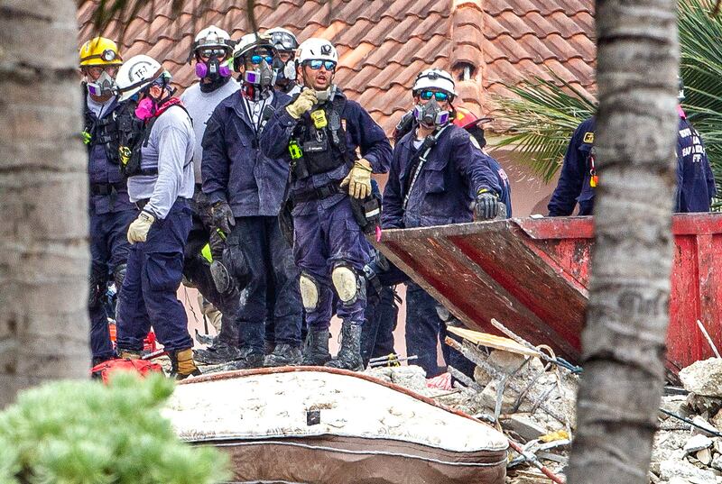 Search and rescue teams look for survivors at the site of the partially collapsed 12-storey apartment block. Miami Herald via AP