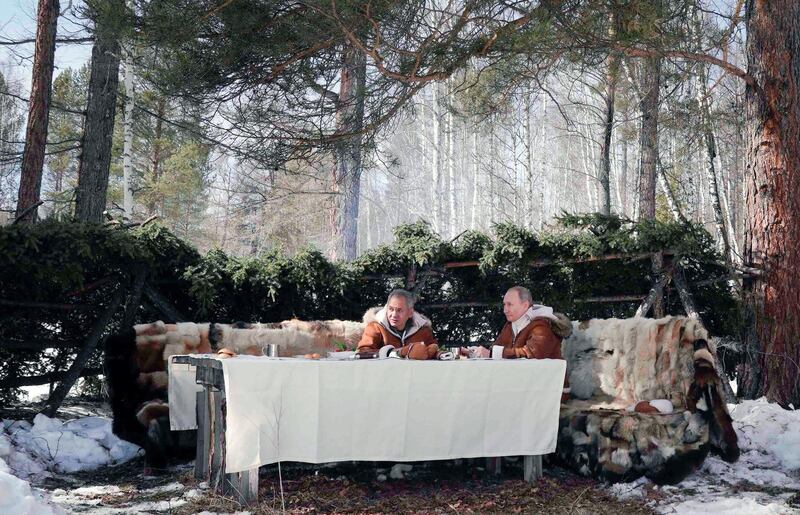Russian President Vladimir Putin and Defence Minister Sergei Shoigu take lunch among the trees of the Siberian taiga. AP Photo