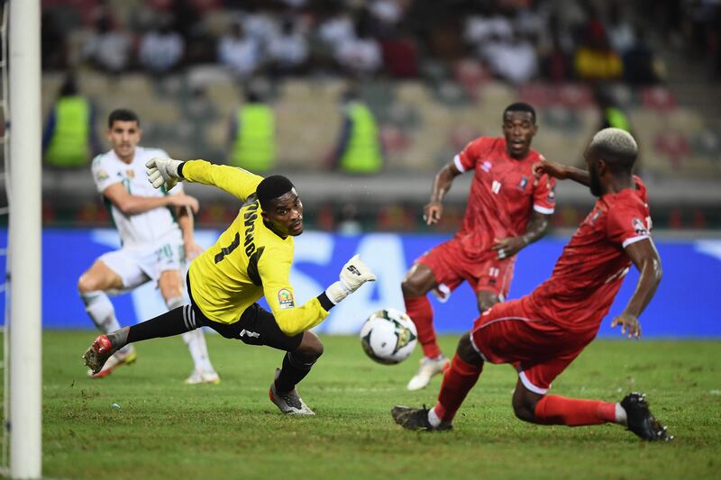 Equatorial Guinea's goalkeeper Jesus Owono dives to thwart an Algeria attack during the Group E Africa Cup of Nations 2021 football match at Stade de Japoma in Douala on January 16, 2022. AFP