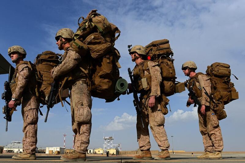 US Marines board a C-130J Super Hercules transport aircraft headed to Kandahar as British and US forces withdraw from the Camp Bastion-Leatherneck complex at Lashkar Gah in Helmand province on October 27, 2014. The US is weighing whether to send thousands more troops back to Afghanistan. AFP PHOTO/WAKIL KOHSAR 