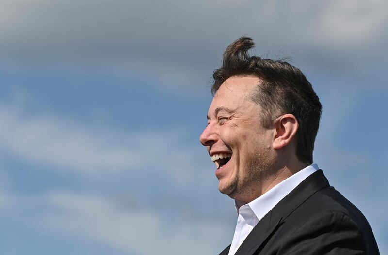 Technology entrepreneur Elon Musk laughs as he visits the Tesla Gigafactory construction site in Gruenheide near Berlin, Germany, Sept. 3, 2020. (Patrick Pleul/dpa via AP)