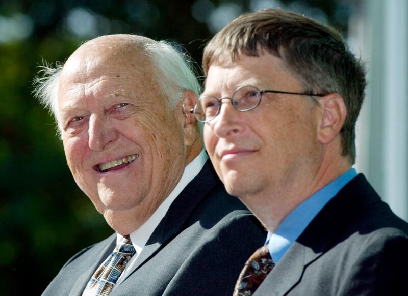 FILE - In this Sept. 12, 2003 file photo, William H. Gates Sr., left, smiles while sitting next to his son, Bill Gates Jr., during the dedication and grand opening of the William H. Gates Hall, new home of the University of Washington School of Law in Seattle. Bill Gates Sr., a lawyer and philanthropist and father of Microsoft co-founder Bill Gates, died Monday, Sept. 14, 2020, at age 94. (AP Photo/John Froschauer, File)