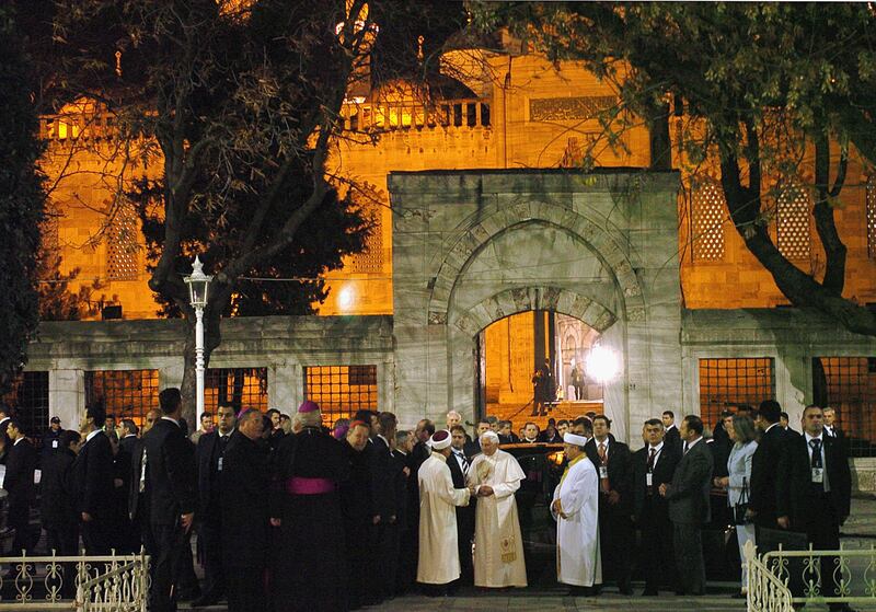 Pope Benedict XVI (Joseph Ratzinger) is welcomed by Mustafa Cagrici, left, Mufti of Istanbul, and imam Emrullah Hatipoglu, right, as he arrives at the Blue Mosque in Istanbul on November 30, 2006. Getty Images