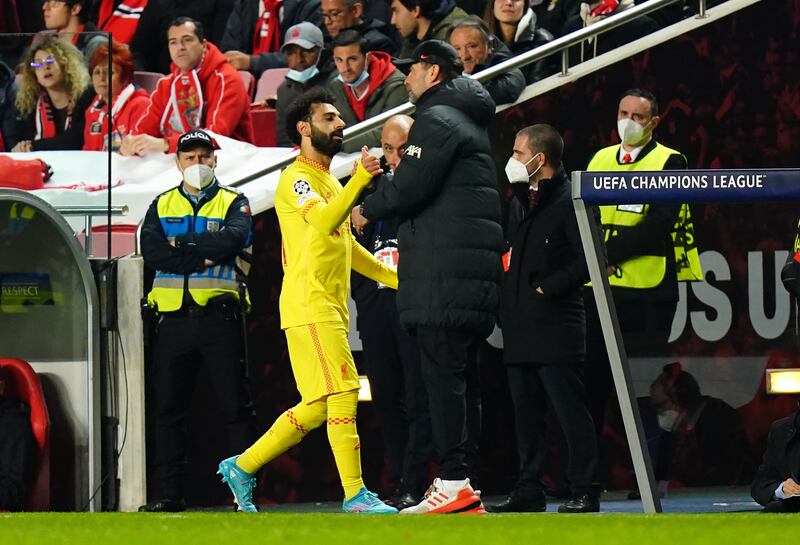 Liverpool's Mohamed Salah greets manager Jurgen Klopp as he leaves the field. PA