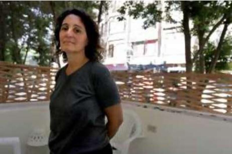 Documentary filmmaker Nadia Kamal stands on the balcony of her flat in Cairo on August 19, 2008. Kamal's first film ìSalata Baladiî has won a number of awards at international film festivals, but it has not yet received the approval of the censorsí in Egypt.  Photo: Victoria Hazou for the National *** Local Caption ***  NadiaKamal.04.JPG