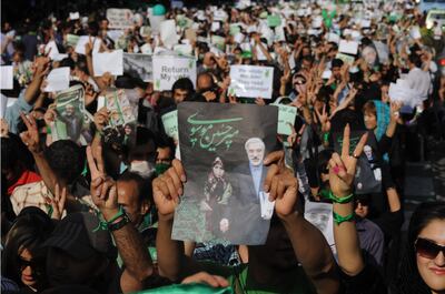 Green Movement demonstrators carry pictures of Mir Hossein Mousavi, the defeated reformist candidate, during a march in Tehran in June 2009. Getty Images