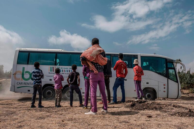 People look at buses carrying relatives of victims of the ET302 flight. AFP