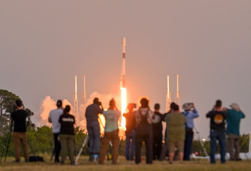Spectators watch the SpaceX Falcon 9 rocket lift-off. Reuters