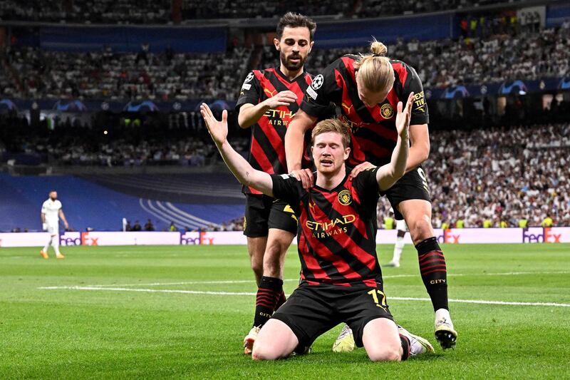Manchester City's Kevin De Bruyne celebrates with teammates after scoring the equaliser against Real Madrid in the Champions League semi-final first-leg match at the Santiago Bernabeu Stadium in Madrid on May 9, 2023. AFP