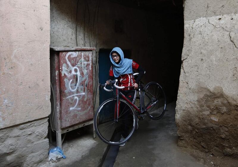 Masooma Alizada, walks with her bicycle in Kabul. Mohammad Ismail / Reuters