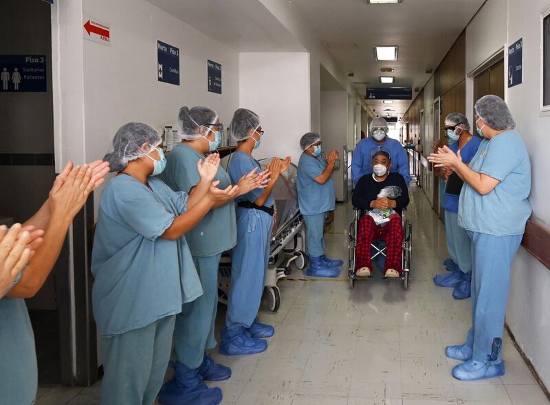 Jose Luis Sanchez is applauded by nurses and doctors as he is discharged after being in hospital for Covid-19 at the Juarez de Mexico Hospital, in Mexico City. AFP