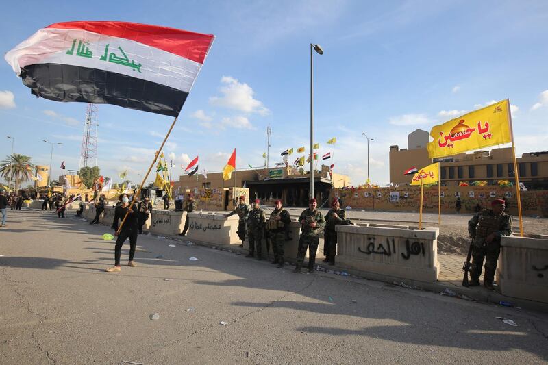 Iraqi security forces are deployed in front of the US embassy in the capital Baghdad, after an order from the Hashed al-Shaabi paramilitary force to supporters to leave the compound.  AFP