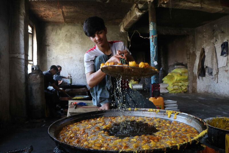 A vendor preparing sweets as time to break the fast approaches, in Herat, Afghanistan.  EPA