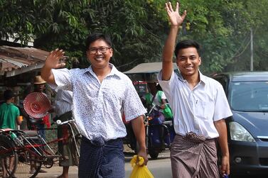 Reuters journalists Wa Lone, left, and Kyaw Soe Oo wave outside Insein prison after being freed in a presidential pardon. AFP