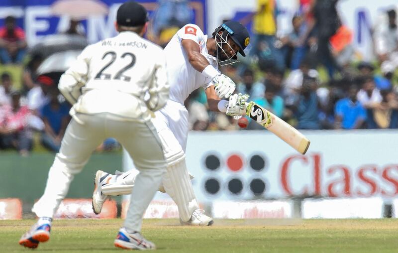 Sri Lanka's cricket captain Dimuth Karunaratne (R) plays a shot during the final day of the opening Test cricket match between Sri Lanka and New Zealand at the Galle International Cricket Stadium in Galle on August 18, 2019. / AFP / ISHARA S. KODIKARA
