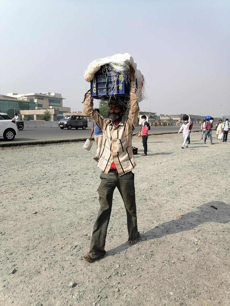 Thousands of men, women and children are walking hundreds of miles in an attempt to go back to their homes. Taniya Dutta/The National