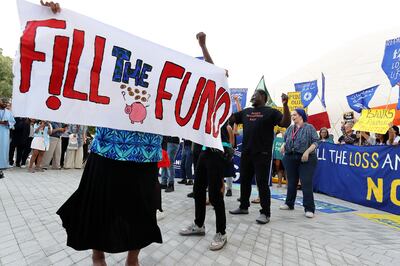 Activists call for rich nations to augment the loss and damage fund at Cop28 in Dubai. Pawan Singh / The National