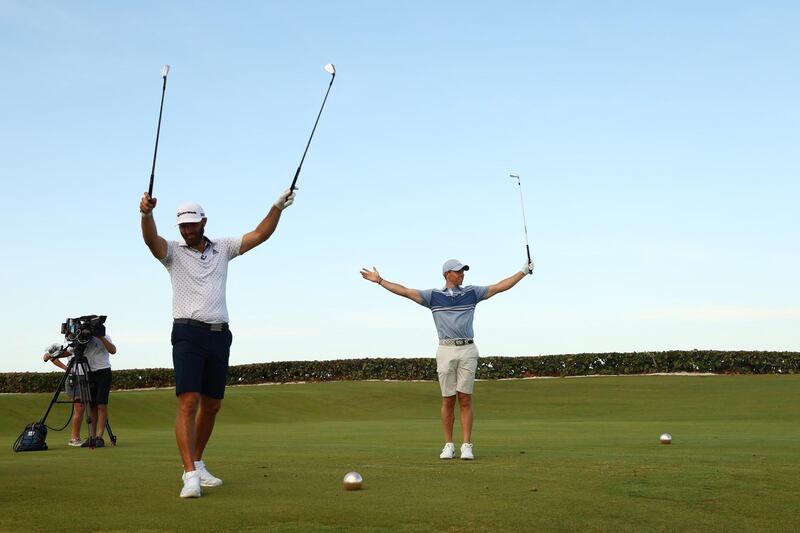 McIlroy and Johnson celebrate the win. AFP