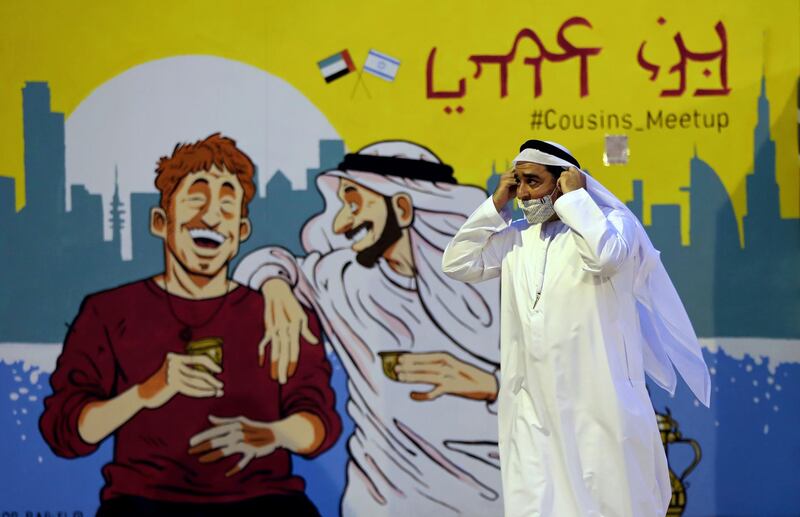 Ahmed Al Mansoori, founder of Crossroads of Civilisation Museum in Dubai, passes by a painting presenting UAE and Israel friendship at an exhibition commemorating the Jewish Holocaust. AP Photo