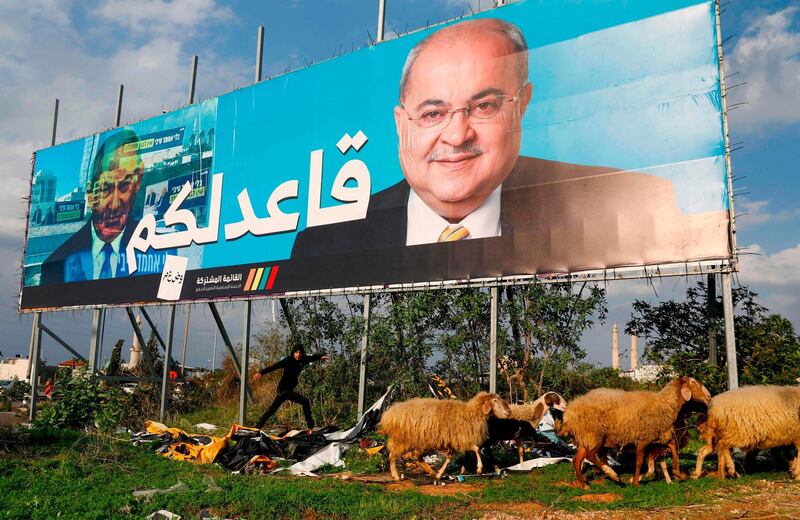 Arab Israeli member of the Joint List Ahmad Tibi on a campaign poster, with the Arabic writing which reads "I am staying seated" in the northern Israeli City of Tayyiba. AFP