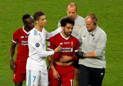 FILE PHOTO: Soccer Football - Champions League Final - Real Madrid v Liverpool - NSC Olympic Stadium, Kiev, Ukraine - May 26, 2018   Liverpool's Mohamed Salah with Sadio Mane and Real Madrid's Cristiano Ronaldo as he is substituted after sustaining an injury   REUTERS/Phil Noble/File Photo