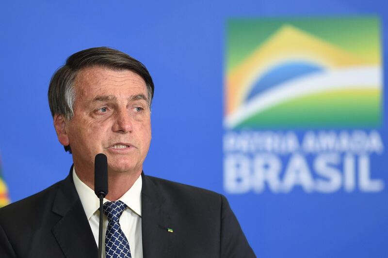 Brazilian President Jair Bolsonaro delivers a speech during the signing ceremony of a new decree that facilitates access to credit for small business and fights the economic impacts resulting from the pandemic of the novel coronavirus, at Planalto Palace in Brasilia, on August 19, 2020. (Photo by EVARISTO SA / AFP)