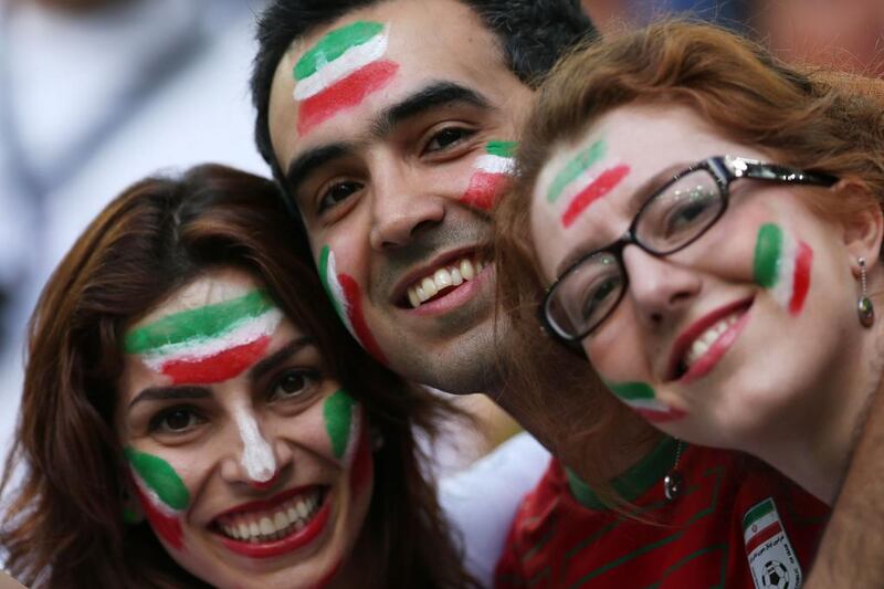 Iranian fans cheer for their team before the start of the Group F football match between Iran and Nigeria. Behrouz Mehri / AFP Photo