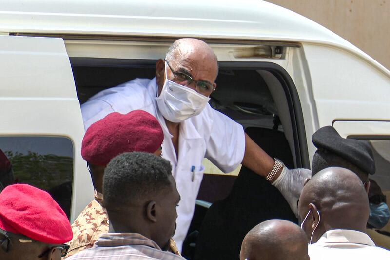 Sudan's ousted President Omar al-Bashir disembarking from a vehicle upon arriving at the courthouse to attend his trial along with 27 other co-accused, in the capital Khartoum.  AFP