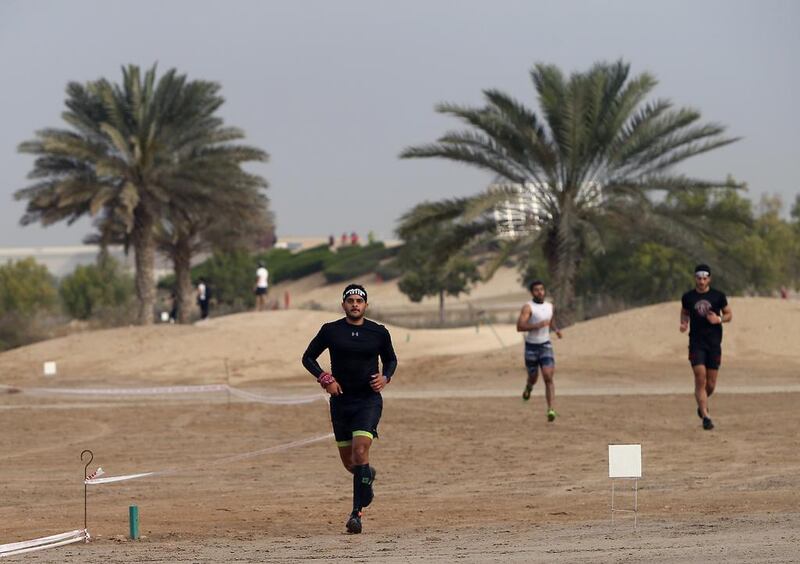 Elite super participants run through desert sand in the XDubai Spartan Race at Al Ghazal Golf Club in Abu Dhabi. Ravindranath K / The National / February 24, 2017