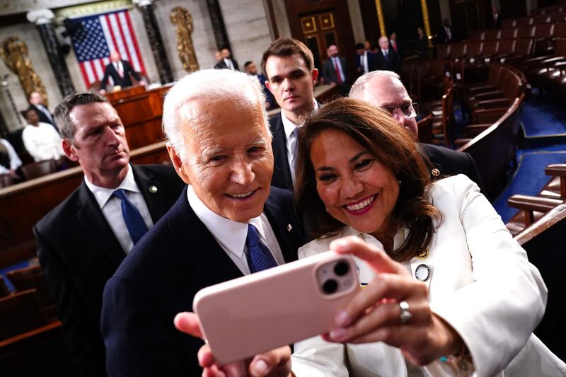 Mr Biden stops for a selfie as he departs the Capital. AFP
