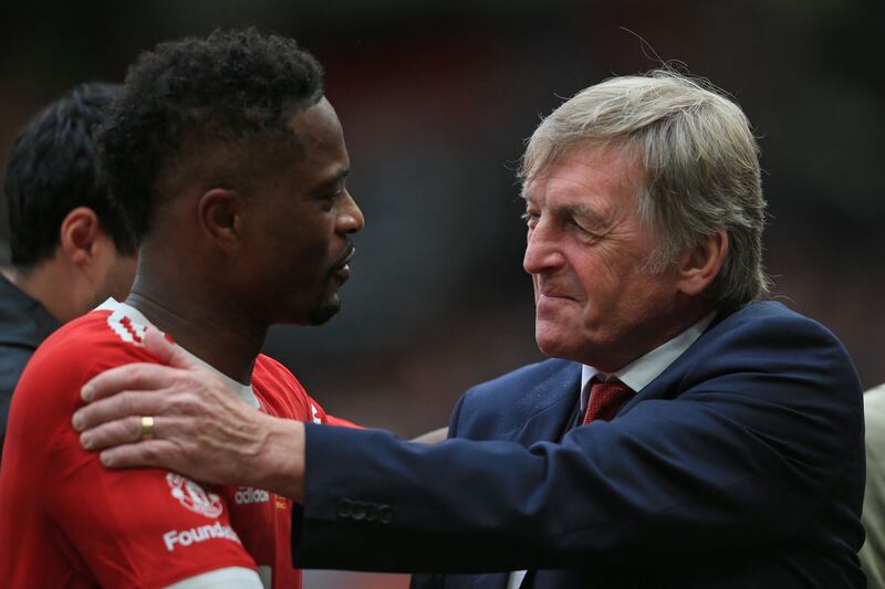 Kenny Dalglish and Manchester United's Patrice Evra. AFP