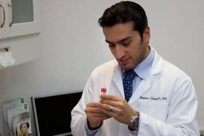 Dr Hassan Galadari at his clinic as he prepares an injection of polycaprolactone. Photo Courtesy of Dr Hassan Galadari