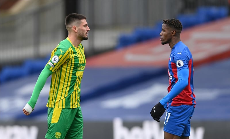 Wilfried Zaha, right, of Crystal Palace argues with Okay Yokuslu of West Brom. AP