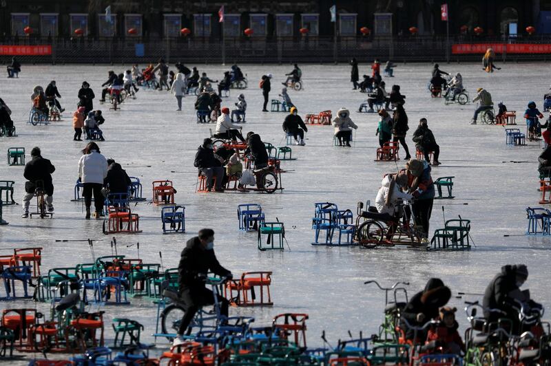 People wearing face masks skate on a frozen lake which has been turned to an ice rink in Beijing, China. Photo taken on January 16, 2021. Reuters