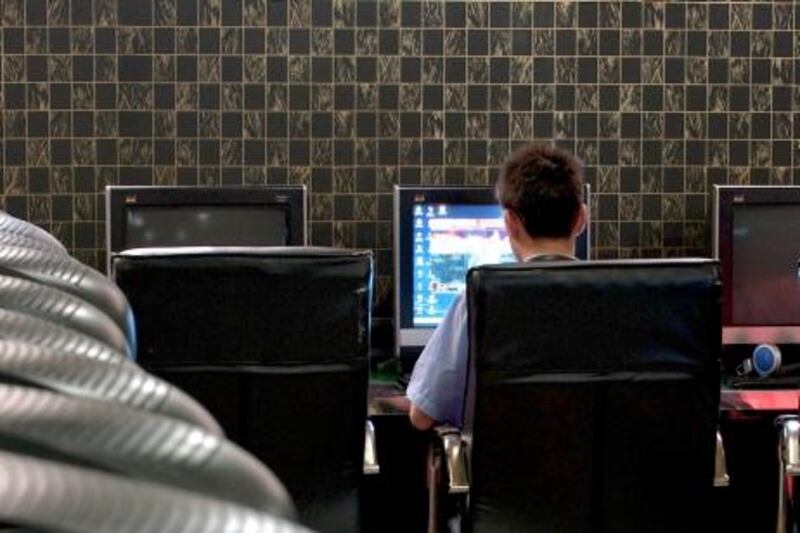 A customer uses a computer at an internet cafe in Beijing, China, on Friday, June 19, 2009. Google Inc. was criticized by Chinese state television and a Web-monitoring group for providing links to obscene content as the government faces pressure from U.S. business organizations to drop a requirement to use filtering software on personal computers. Photographer: Stefen Chow/Bloomberg News