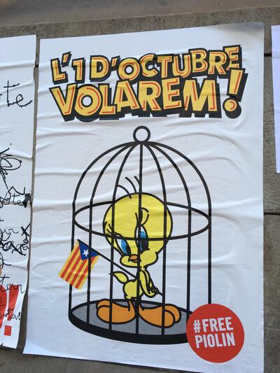 One poster plastered on buildings shows Tweety encaged — presumably by Madrid — but defiantly holding aloft the Catalan flag, known as the Senyera. Richard Ferraris