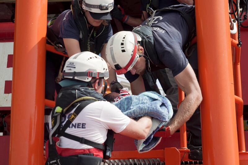 A newborn baby is carried onto the Ocean Viking humanitarian rescue ship after a rescue operation some 53 nautical miles (98 kilometers) from the coast of Libya in the Mediterranean Sea. The humanitarian rescue ship Ocean Viking pulled 48 people from a small and overcrowded wooden boat including a newborn and a pregnant woman. AP Photo