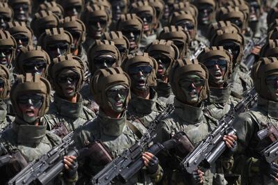 Korean People's Army (KPA) soldiers march during a mass rally on Kim Il Sung square in Pyongyang on September 9, 2018. - North Korea held a military parade to mark its 70th birthday, but refrained from showing off the intercontinental ballistic missiles that have seen it hit with multiple international sanctions. (Photo by Ed JONES / AFP)