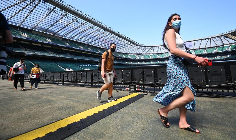 Socially distanced people arrive at Twickenham Stadium for their first Covid jabs. EPA