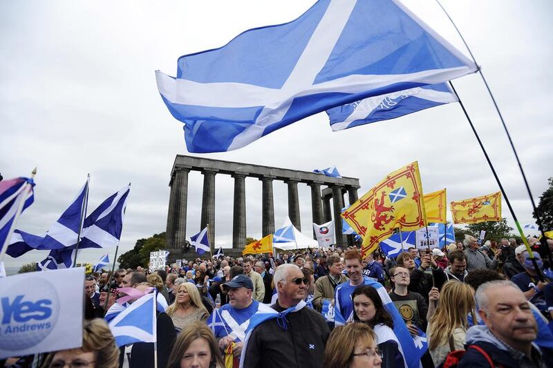 Pro-independence supporters wave the Saltire as they gather in Edinburgh for a march and rally in support of a Scottish independence referendum to be held in September. AFP / September 21, 2013 