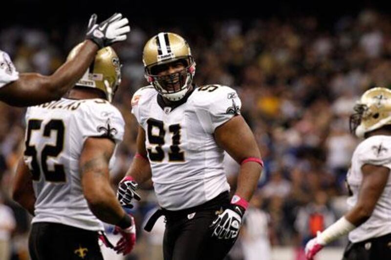 Will Smith, centre, the New Orleans defensive end, celebrates the Saints’ emphatic victory against the Indianapolis Colts on Sunday. The score tied the league’s total points record.